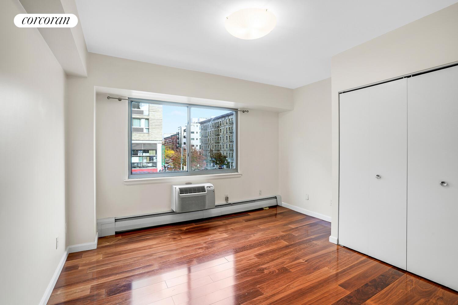 300 West 145th Street, Unit 1K Manhattan, NY 10039 - Photo 12 of 28 a view of empty room with wooden floor and fan