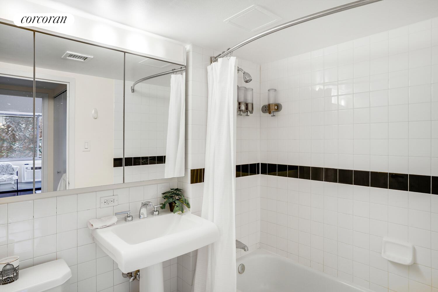 300 West 145th Street, Unit 1K Manhattan, NY 10039 - Photo 13 of 28 a bathroom with a sink and a mirror