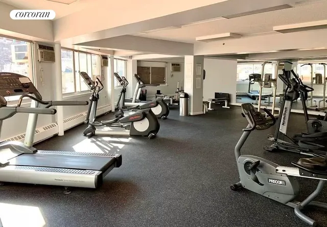 a room with gym equipment and large mirror