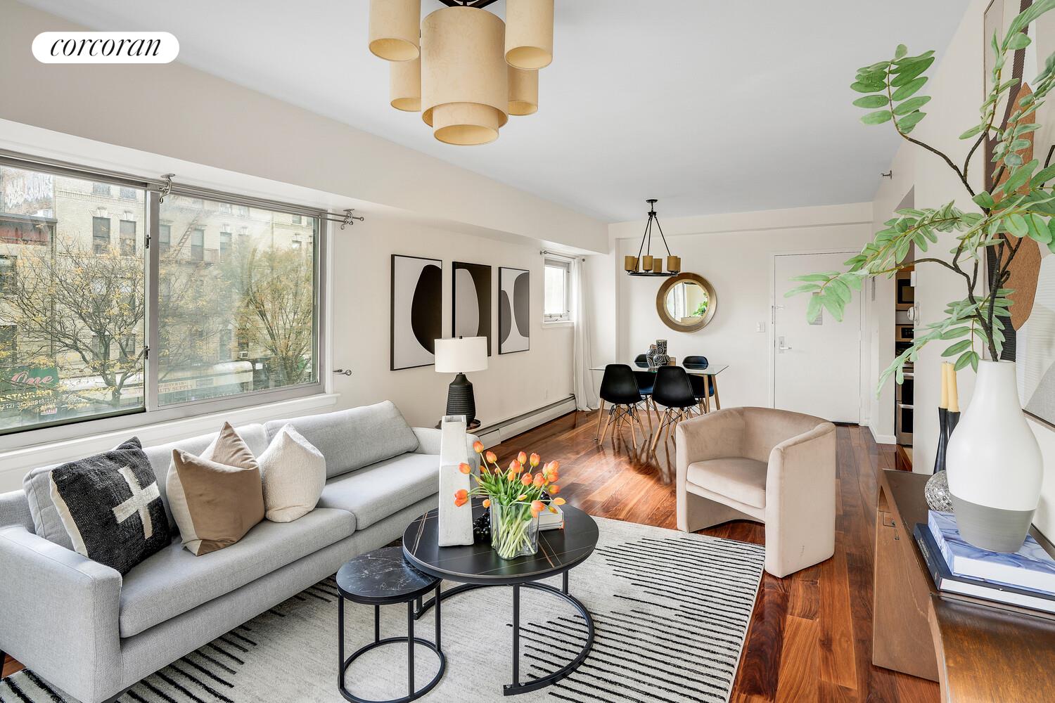 300 West 145th Street, Unit 1K Manhattan, NY 10039 - Photo 4 of 28 a living room with furniture a couch and a chandelier