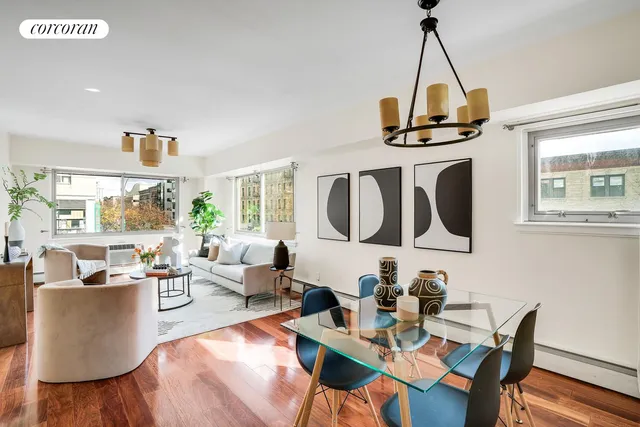 a living room with furniture a window and a table