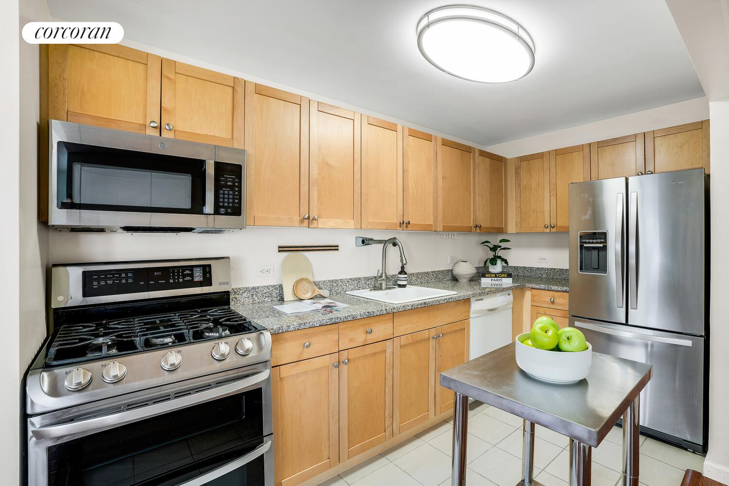 300 West 145th Street, Unit 1K Manhattan, NY 10039 - Photo 6 of 28 a kitchen with stainless steel appliances granite countertop a stove refrigerator and a microwave