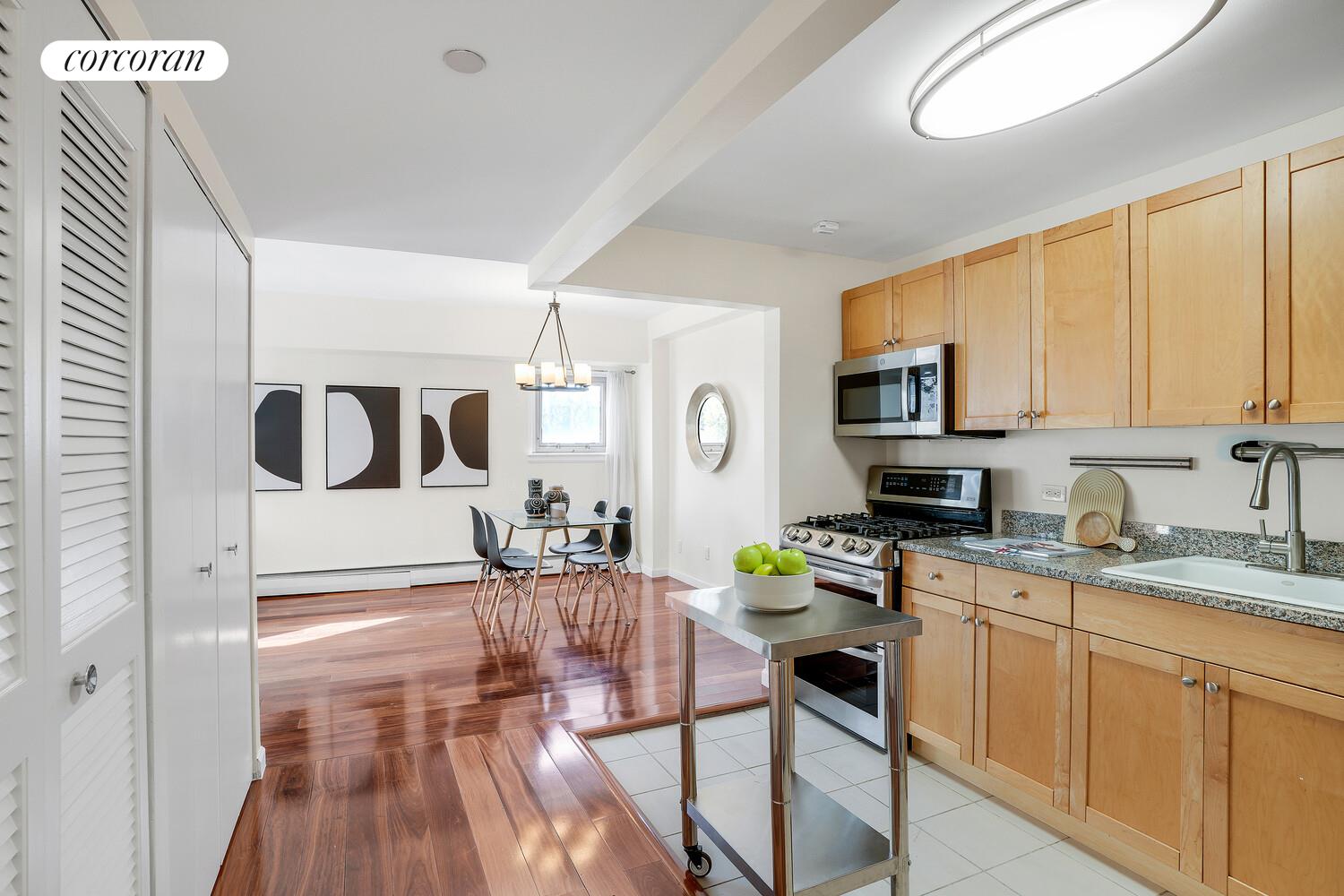 300 West 145th Street, Unit 1K Manhattan, NY 10039 - Photo 7 of 28 a kitchen that has a lot of cabinets in it and appliances