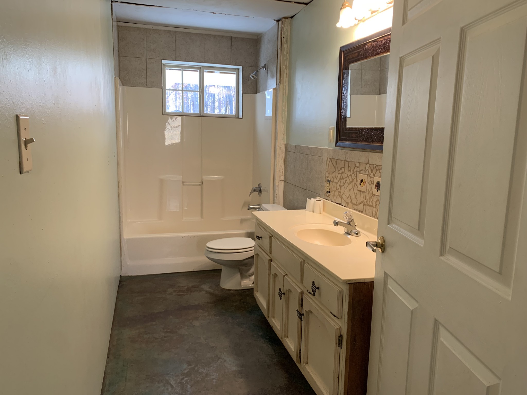 581 Nim Road Red Boiling Springs, TN 37150 - Photo 10 of 26 a bathroom with a sink a toilet and a mirror