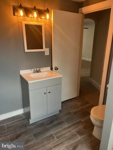 a bathroom with a sink mirror vanity and toilet