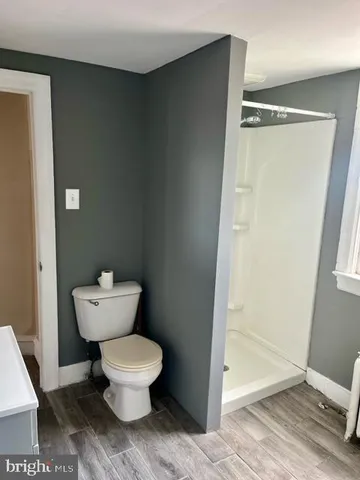 a white toilet sitting next to a bathroom sink