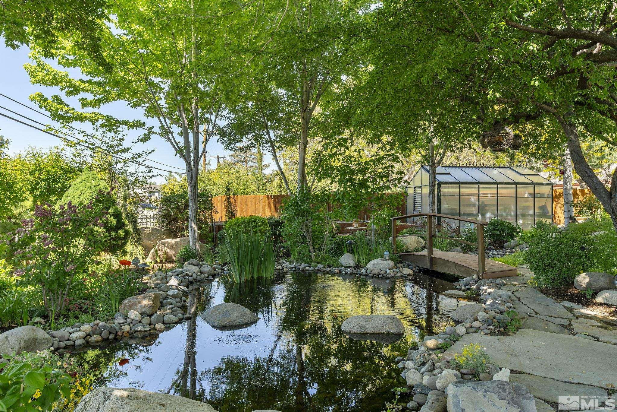 930 Spanish Springs Road Sparks, NV 89434 - Photo 13 of 40 a view of a swimming pool with lawn chairs under an umbrella