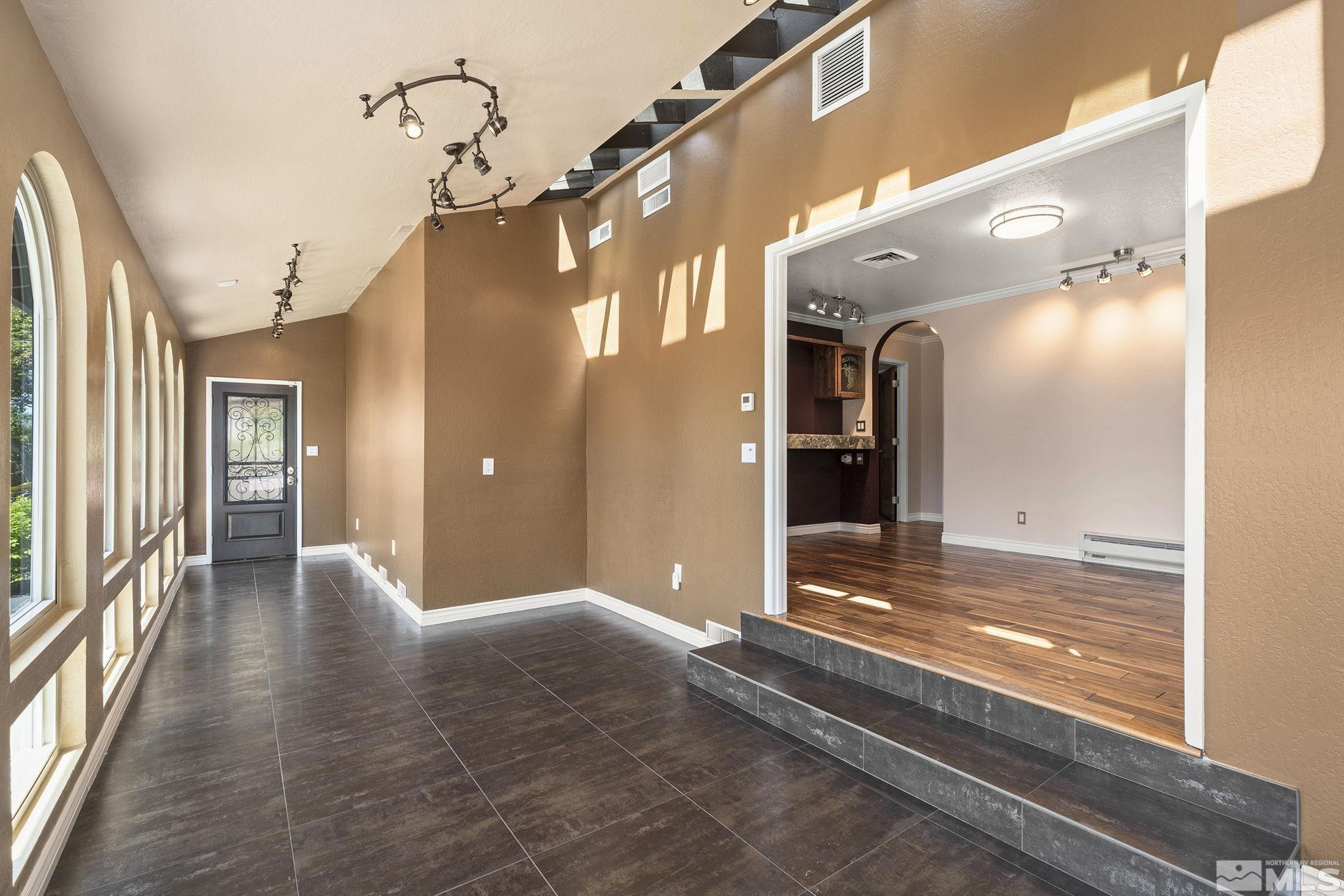 930 Spanish Springs Road Sparks, NV 89434 - Photo 20 of 40 a view of a hallway with wooden floor and a living room