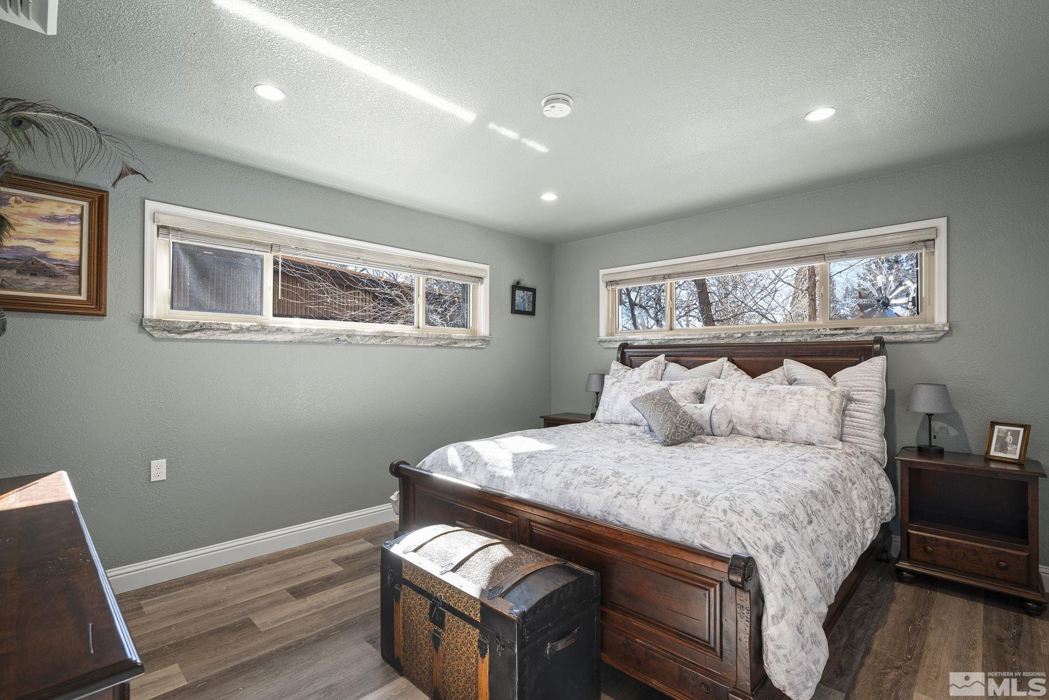 930 Spanish Springs Road Sparks, NV 89434 - Photo 30 of 40 a bedroom with a bed and wooden floor