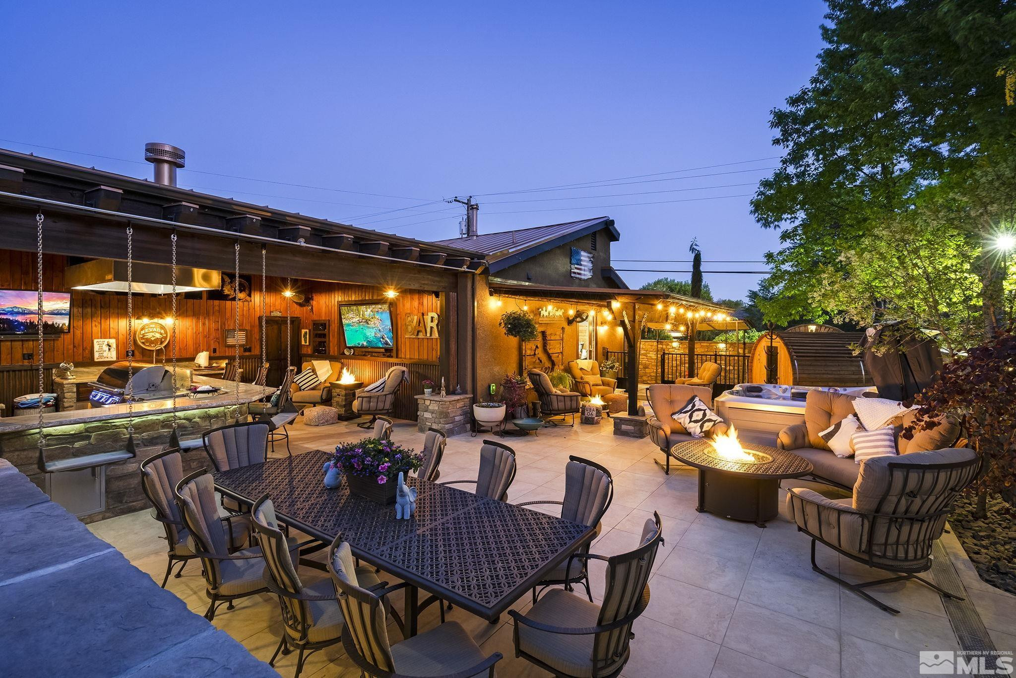 930 Spanish Springs Road Sparks, NV 89434 - Photo 3 of 40 a view of a patio with dining table and chairs with a barbeque grill and couches