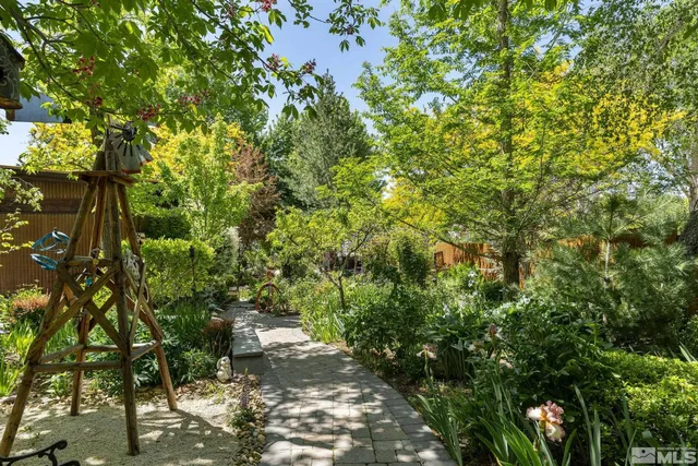 a view of a patio with table and chairs and potted plants