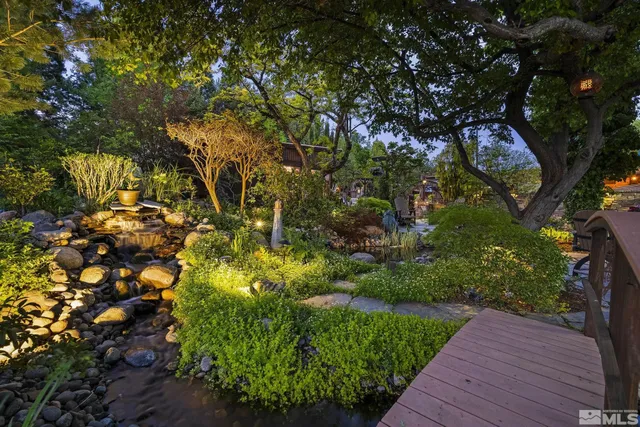 a view of a house with backyard sitting area and swimming pool