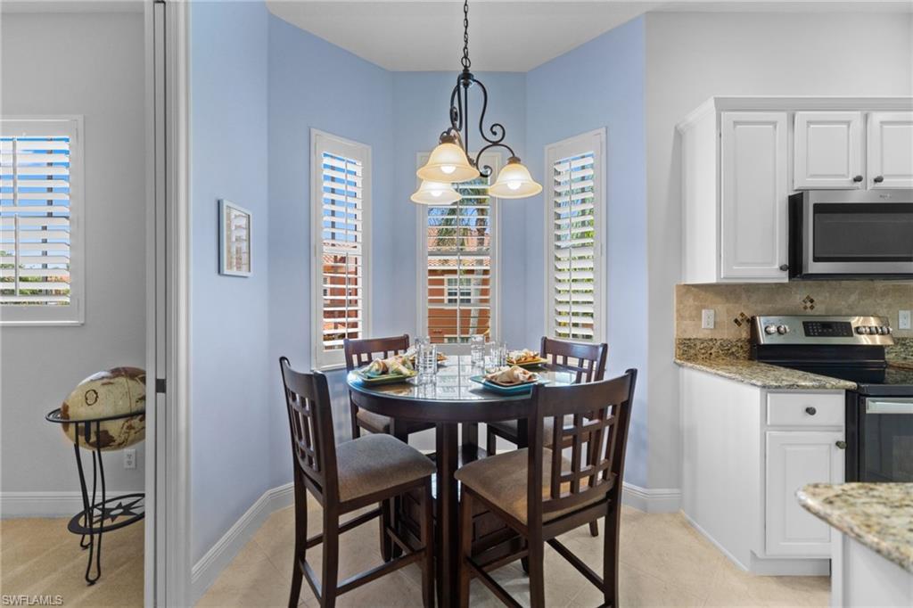 6414 Legacy Circle, Unit 903 Naples, FL 34113 - Photo 14 of 50 a dining room with furniture and window
