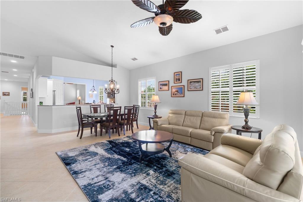 6414 Legacy Circle, Unit 903 Naples, FL 34113 - Photo 20 of 50 a living room with furniture and a large window
