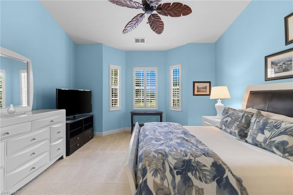 6414 Legacy Circle, Unit 903 Naples, FL 34113 - Photo 26 of 50 a bedroom with a bed and a television