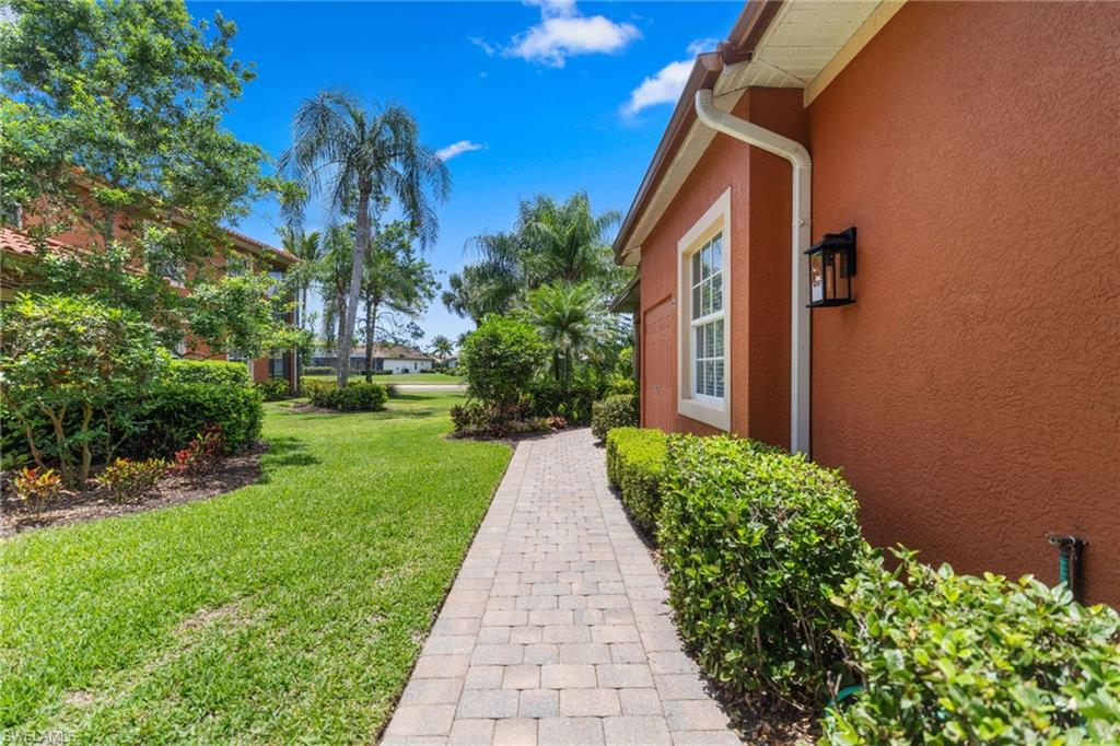 6414 Legacy Circle, Unit 903 Naples, FL 34113 - Photo 4 of 50 a view of a pathway with a garden