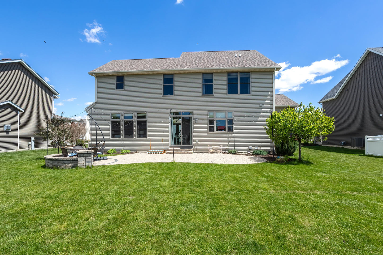 5700 Emily Road Bettendorf, IA 52722 - Photo 54 of 58 a front view of a house with patio and garden