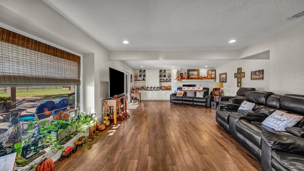 1003 Lamkin Road Mineral Wells, TX 76067 - Photo 5 of 40 Living area with wood finished floors, a textured ceiling, and recessed lighting