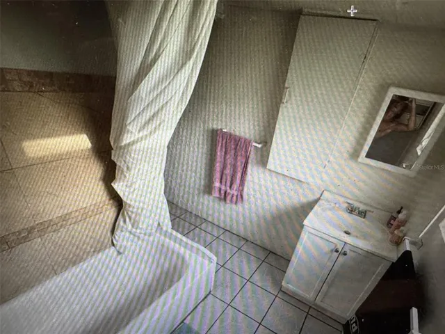 a view of backyard with wooden fence and trees