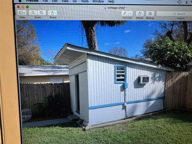 a backyard of a house with childrens swings and slide