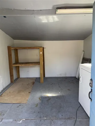 a view of a chair and table in backyard of the house