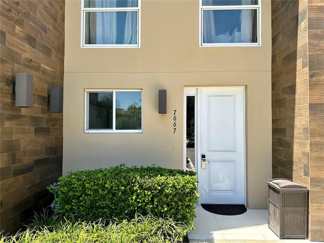 a dining room with furniture and a potted plant