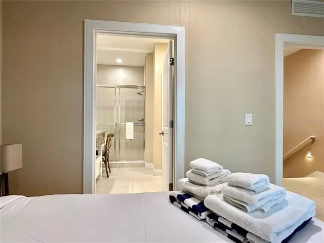 a bedroom with two beds and a large window