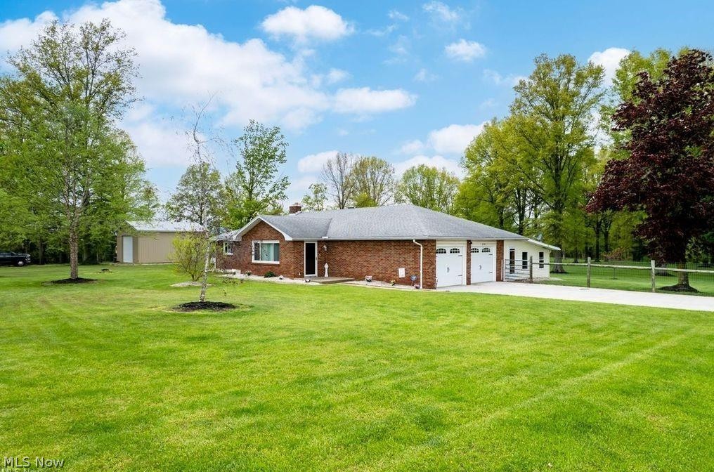 2530 Tuckahoe Road Wooster, OH 44691 - Photo 11 of 29 Brick ranch-style home featuring an attached three-car garage with white doors