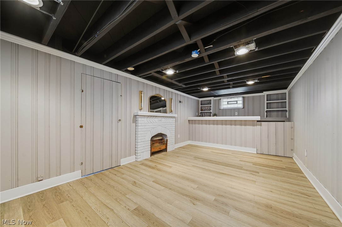 2231 Brockway Road University Heights, OH 44118 - Photo 29 of 46 Recreation room featuring wood-finish flooring, light-toned vertical paneling, and an exposed black ceiling