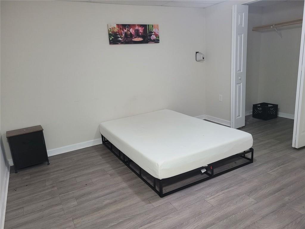 1681 Atherton Circle Decatur, GA 30035 - Photo 7 of 17 a large bed sitting in a bedroom next to a wall with wooden floor