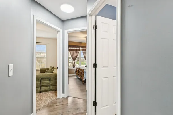 a view of a hallway with a living room and furniture