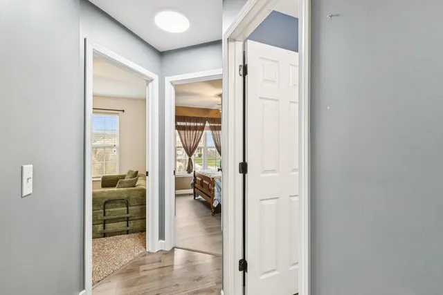 a view of a hallway with a living room and furniture