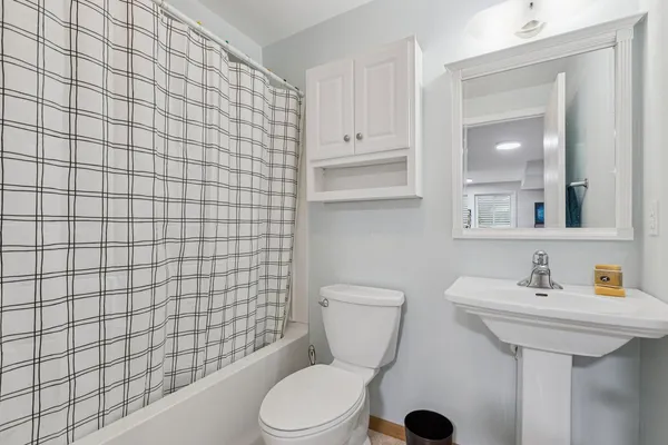 a bathroom with a sink a toilet and mirror