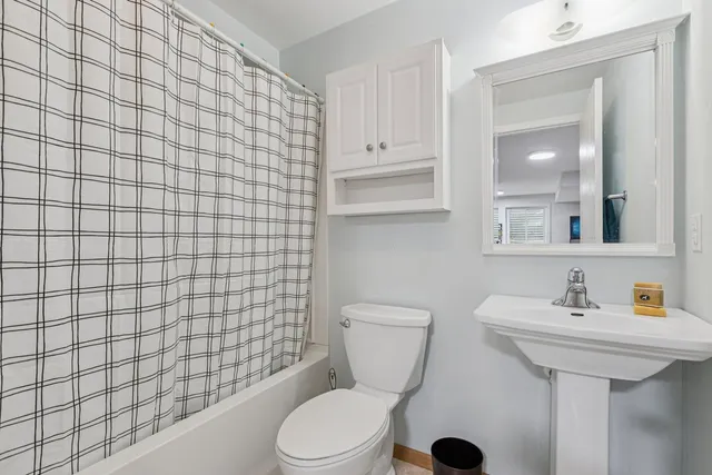 a bathroom with a sink a toilet and mirror