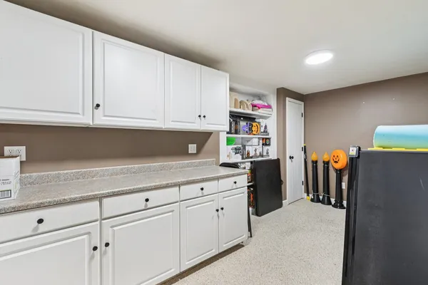 a kitchen with stainless steel appliances granite countertop a refrigerator sink and cabinets