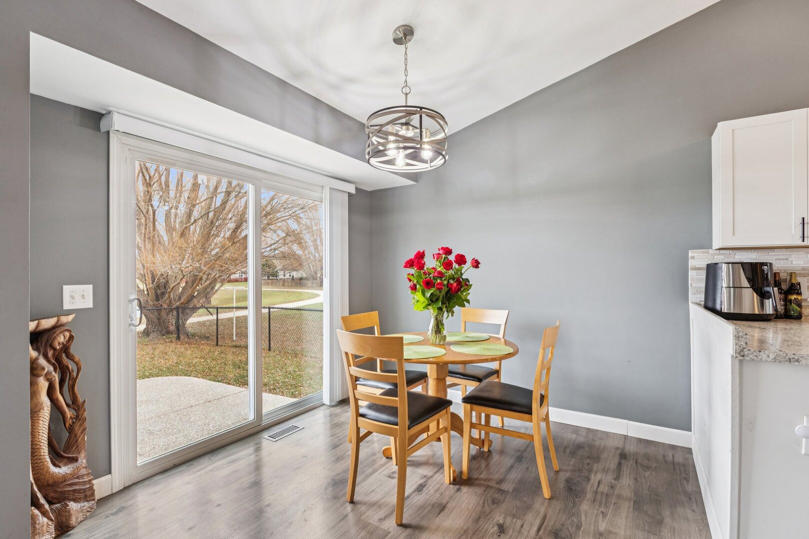 1024 Misty Landing Court Malta, IL 60150 - Photo 5 of 28 a dining room with furniture a chandelier and wooden floor