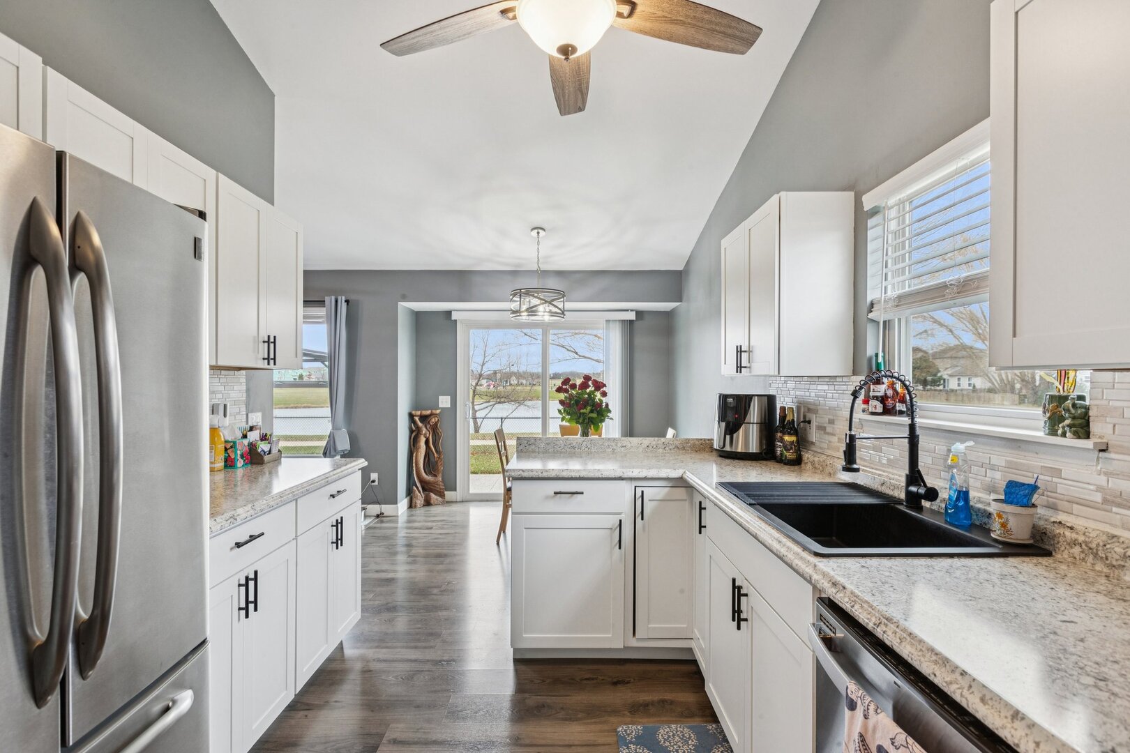 1024 Misty Landing Court Malta, IL 60150 - Photo 6 of 28 a kitchen with white cabinets and white appliances
