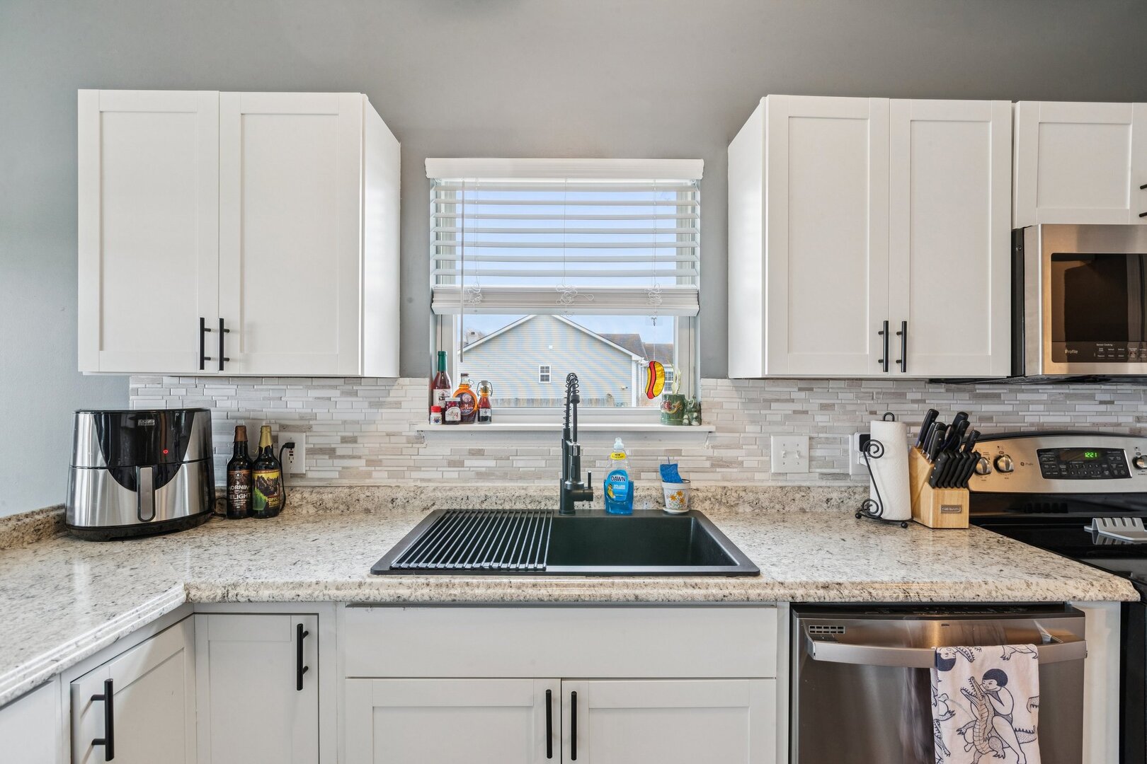 1024 Misty Landing Court Malta, IL 60150 - Photo 8 of 28 a kitchen with stainless steel appliances granite countertop a sink a stove and cabinets