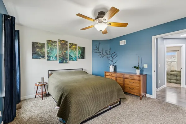 a bedroom with a bed and a chandelier