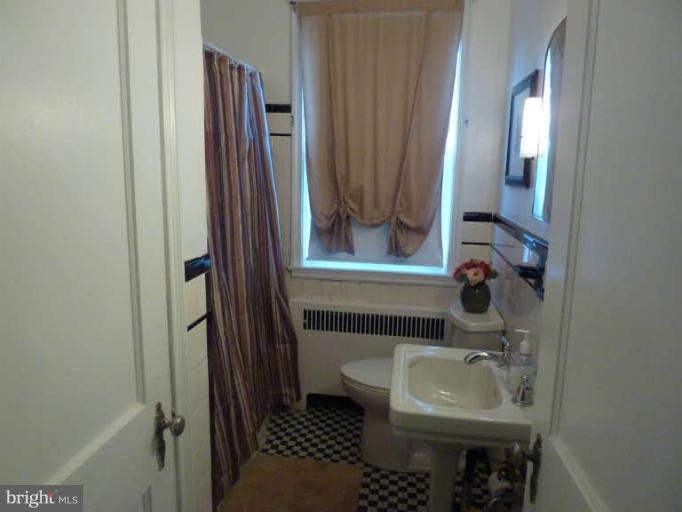 619 Stamford Road Baltimore, MD 21229 - Photo 11 of 17 a bathroom with a sink toilet and shower