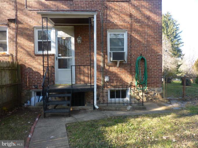 619 Stamford Road Baltimore, MD 21229 - Photo 14 of 17 a front view of a house with a yard