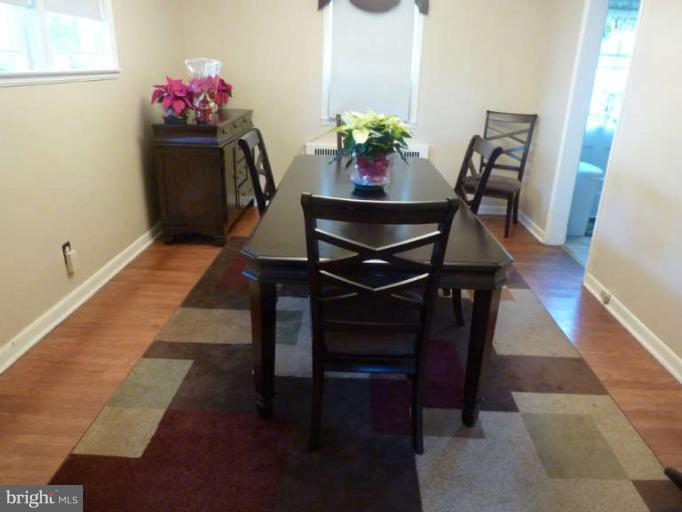 619 Stamford Road Baltimore, MD 21229 - Photo 5 of 17 a dining room with furniture and wooden floor