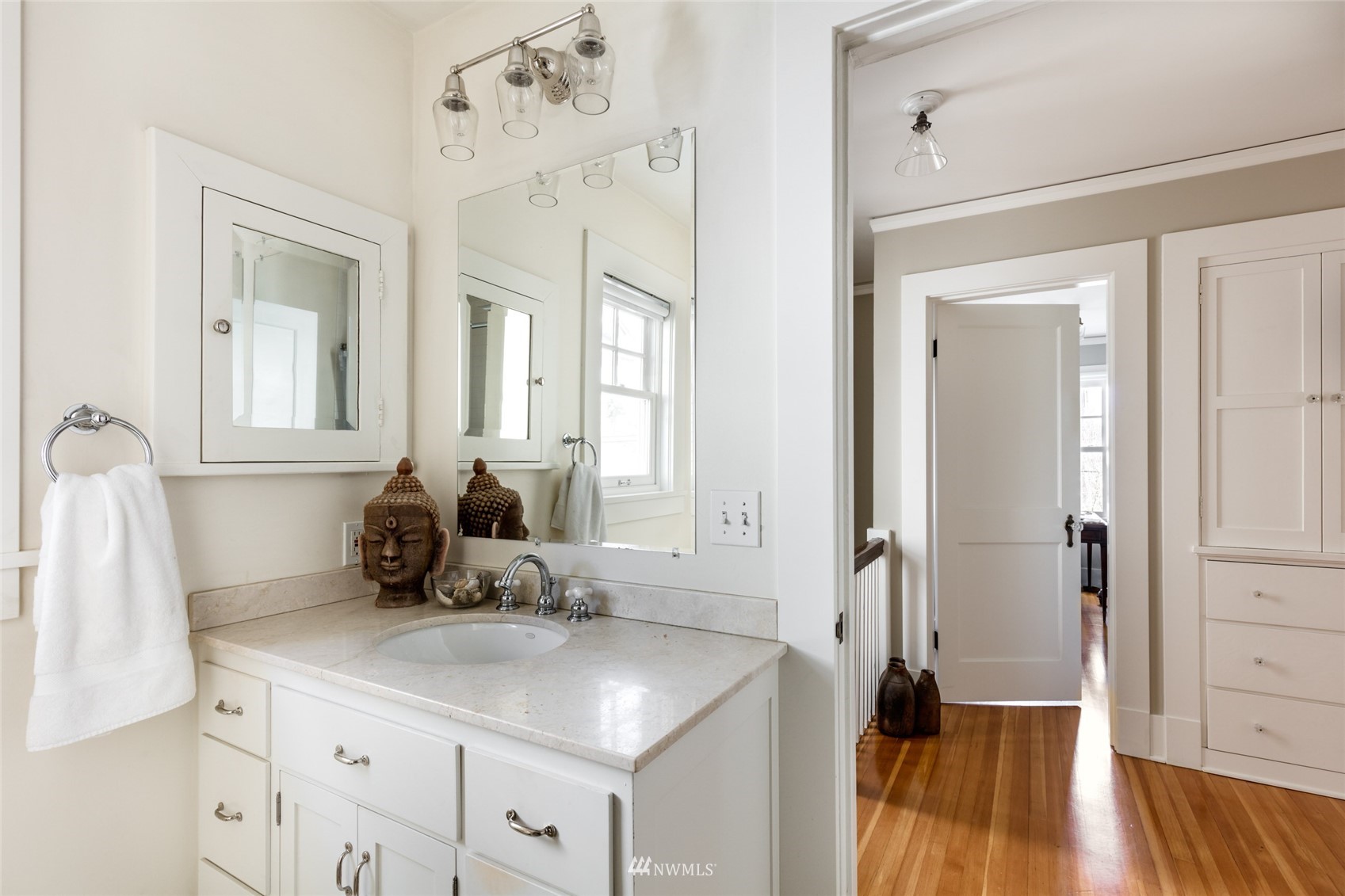 617 35th Avenue Seattle, WA 98122 - Photo 27 of 40 a view of a hallway with wooden floor and a bathroom