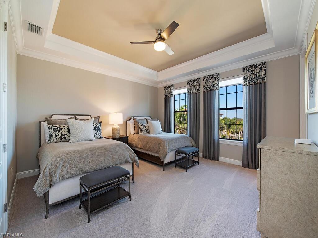 16444 Carrara Way, Unit 7301 Naples, FL 34110 - Photo 12 of 22 a spacious bedroom with two beds and large windows