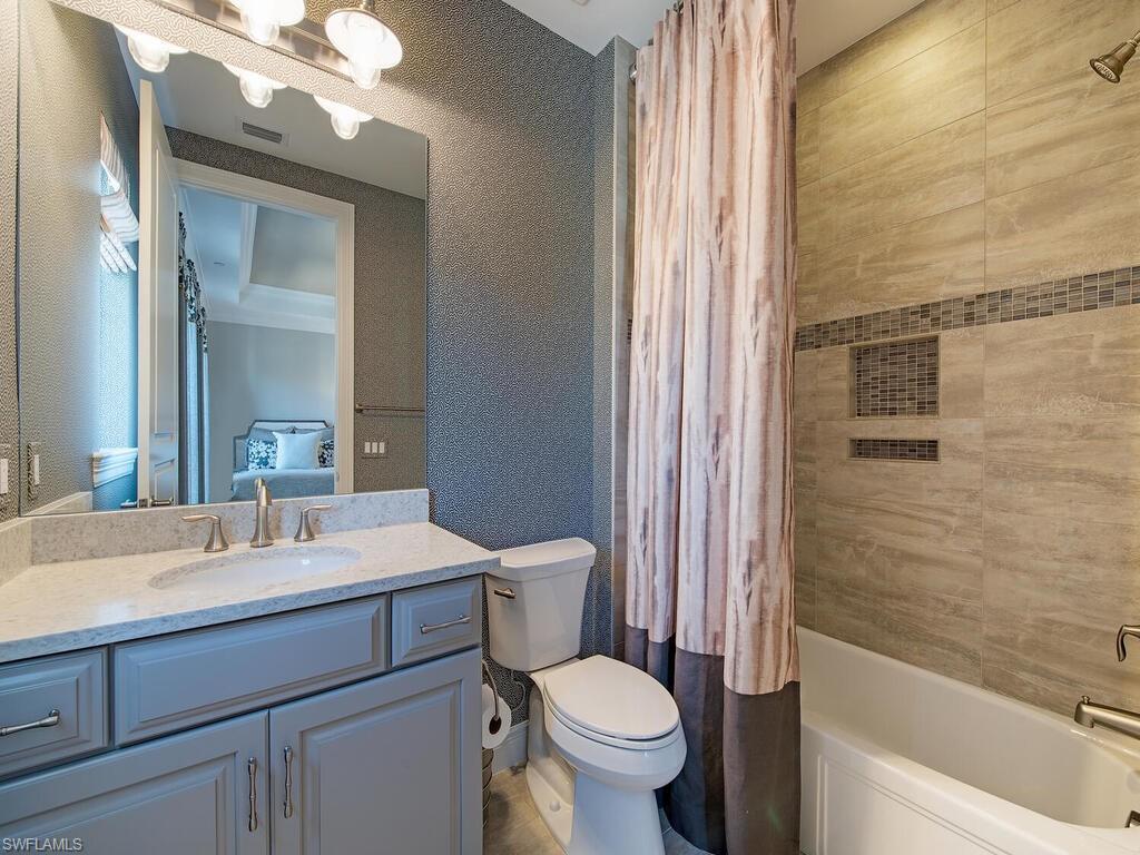 16444 Carrara Way, Unit 7301 Naples, FL 34110 - Photo 13 of 22 a bathroom with a sink a toilet and shower