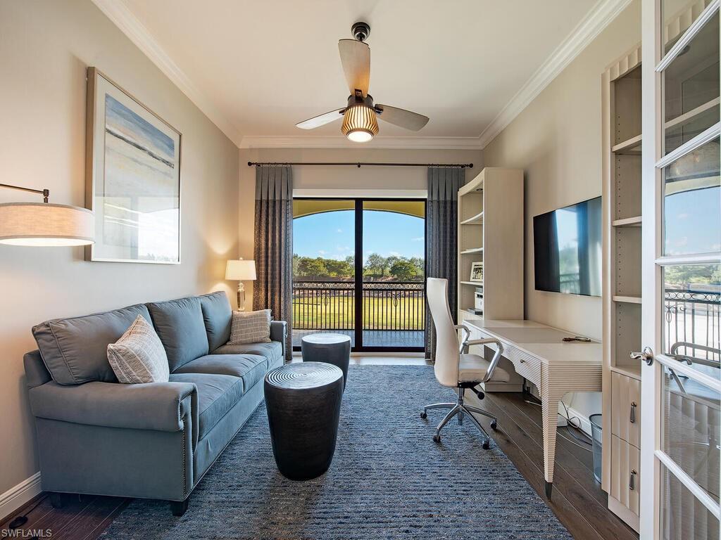 16444 Carrara Way, Unit 7301 Naples, FL 34110 - Photo 16 of 22 a living room with furniture large window and flat screen tv