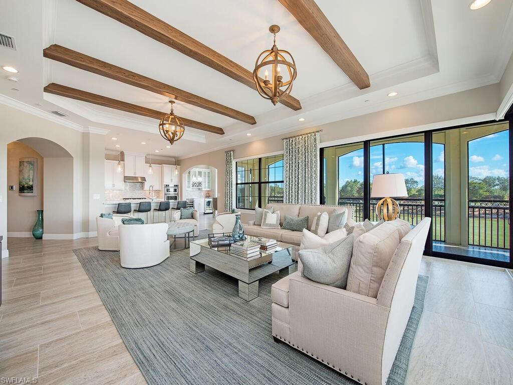 16444 Carrara Way, Unit 7301 Naples, FL 34110 - Photo 3 of 22 a living room with furniture and a large window