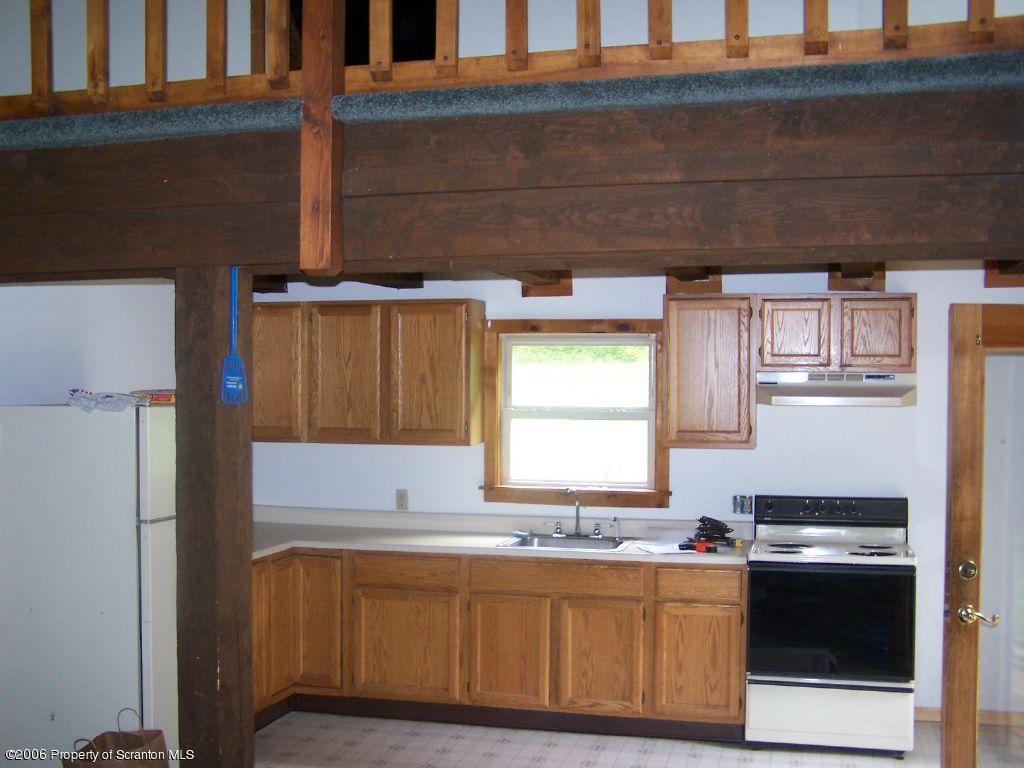 55 East Lemon Road Tunkhannock, PA 18657 - Photo 3 of 8 a kitchen with stainless steel appliances a stove a sink and a refrigerator