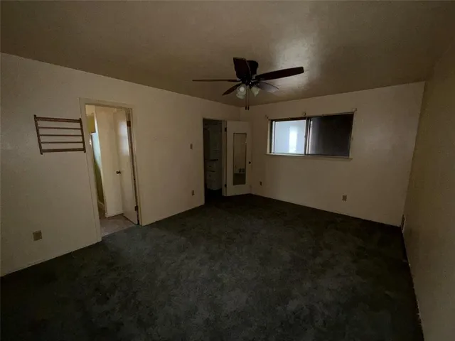 a bathroom with a granite countertop toilet sink and mirror