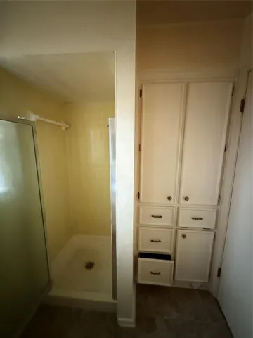 a view of walk in closet with empty racks